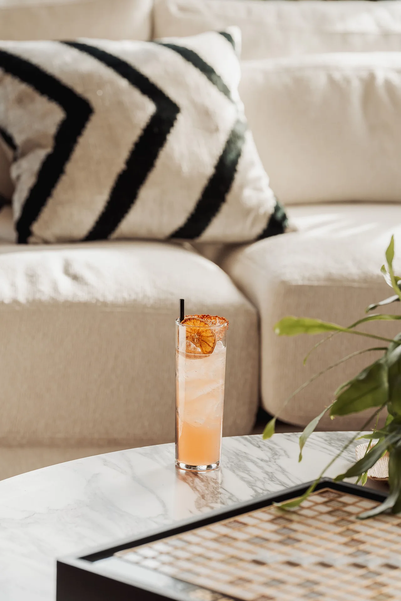 Tall cocktail beside a lounge sofa at GrowthX Launch Party