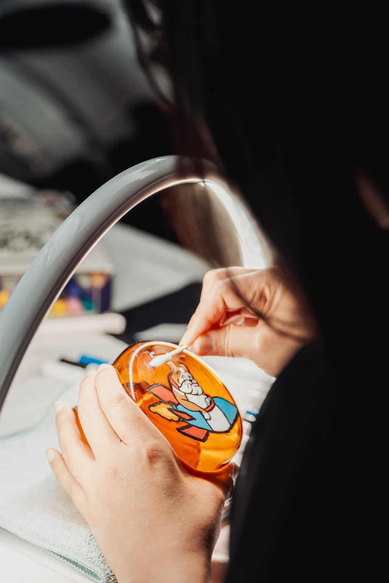 Guest painting a colorful design on a small container at GrowthX Launch Party