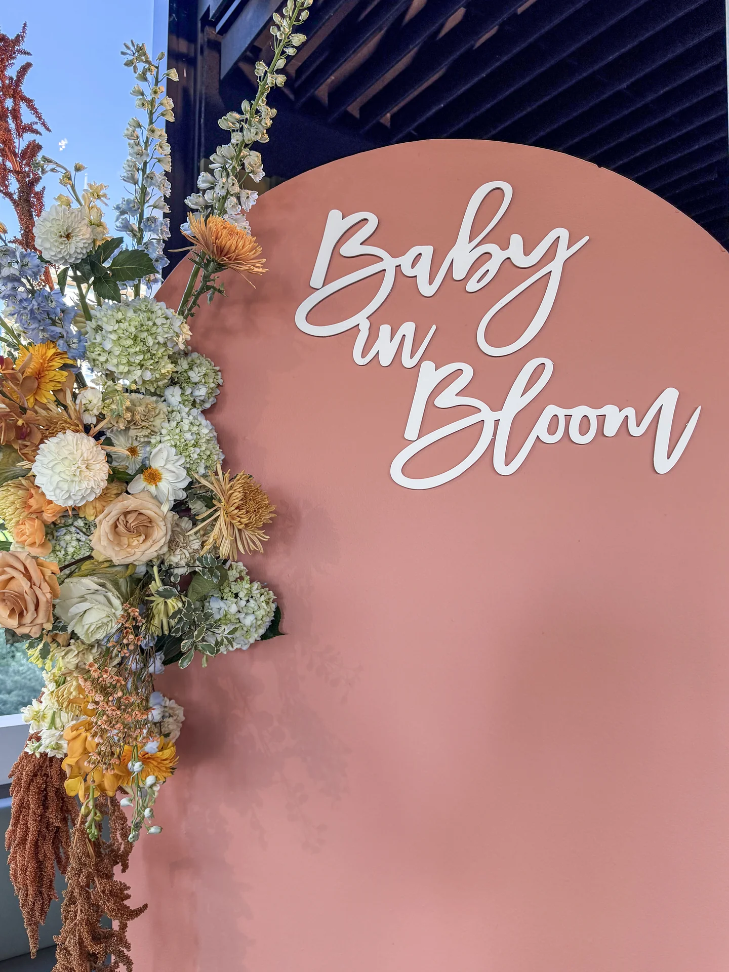Baby in Bloom sign surrounded by flowers at Bloom Baby Shower