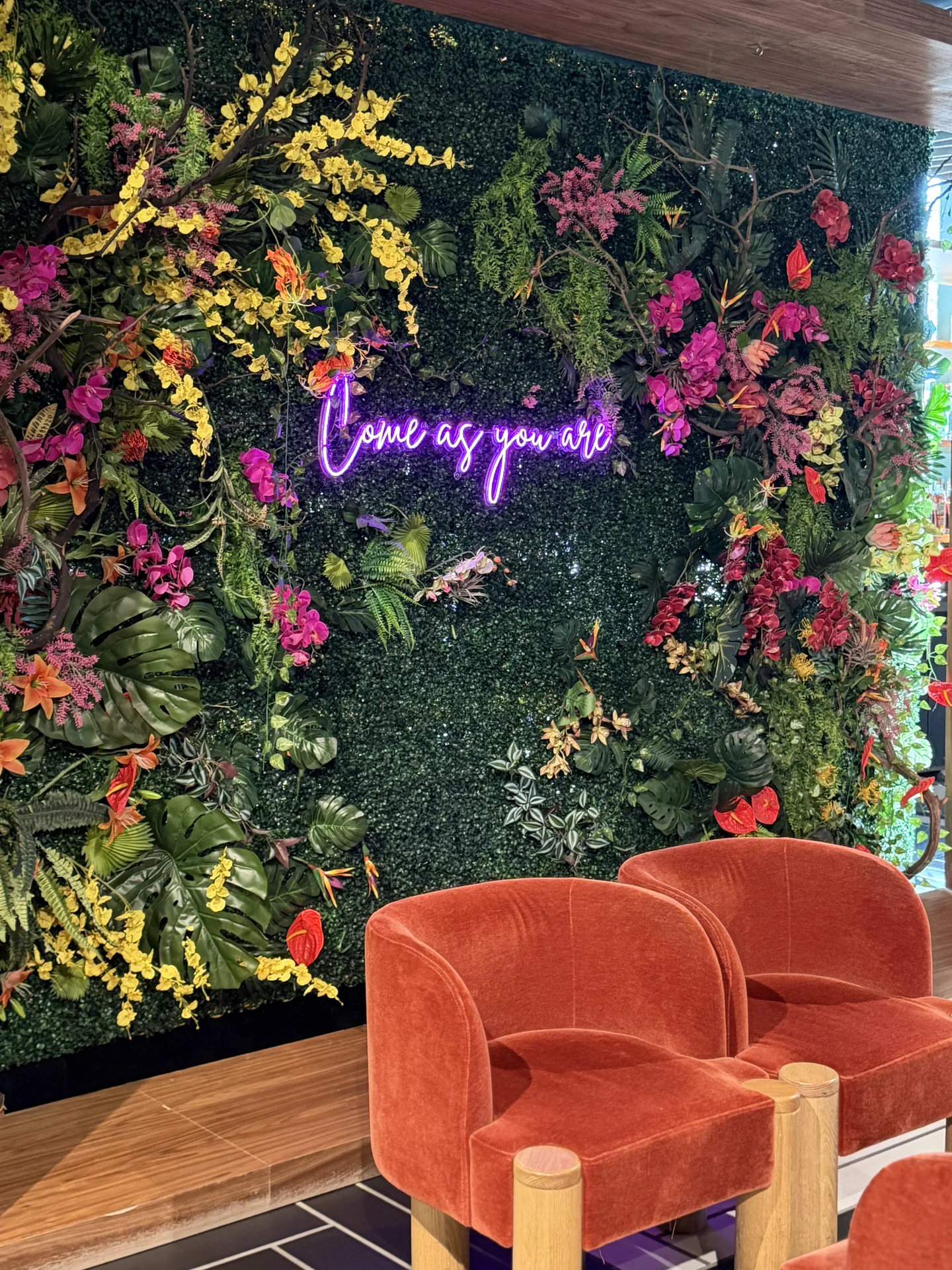 Floral photo backdrop and lounge chair at Bloom Baby Shower