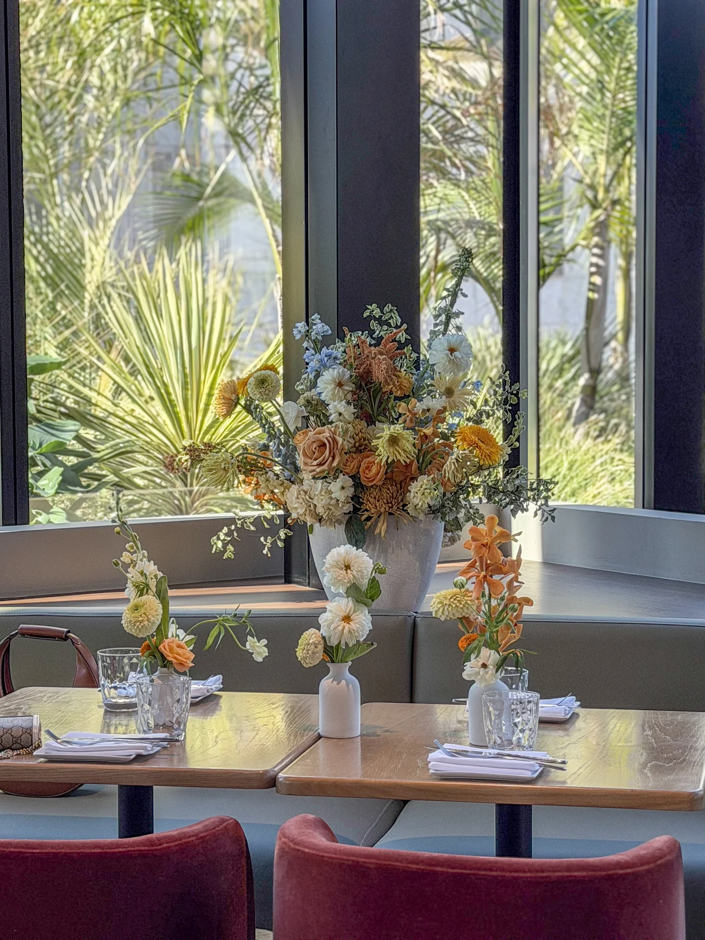 Flowers and place settings beside a window at Bloom Baby Shower