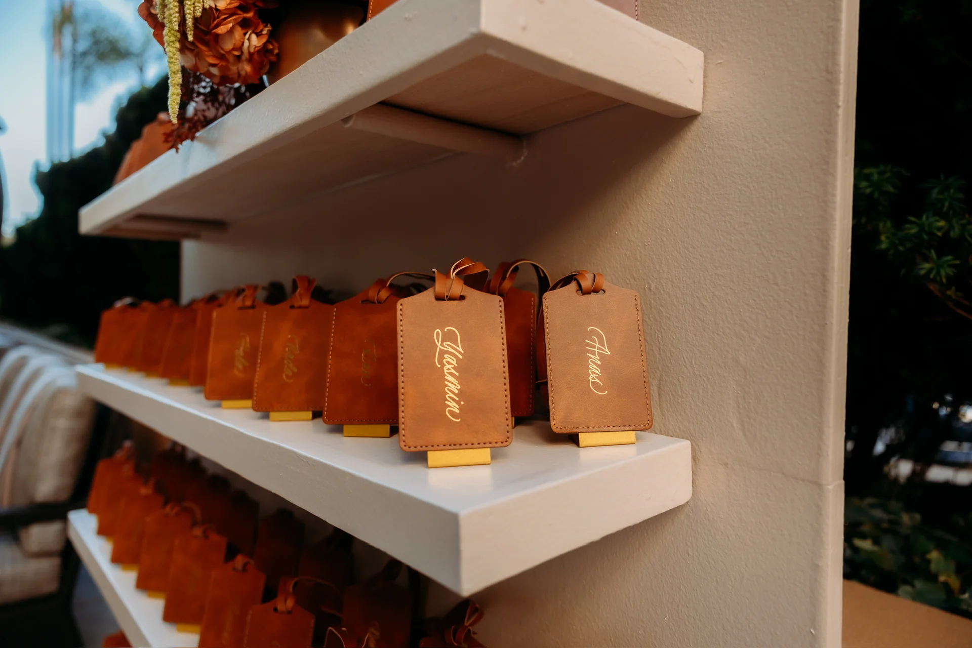 Orange favor bags on a display shelf at Deena 40th Birthday