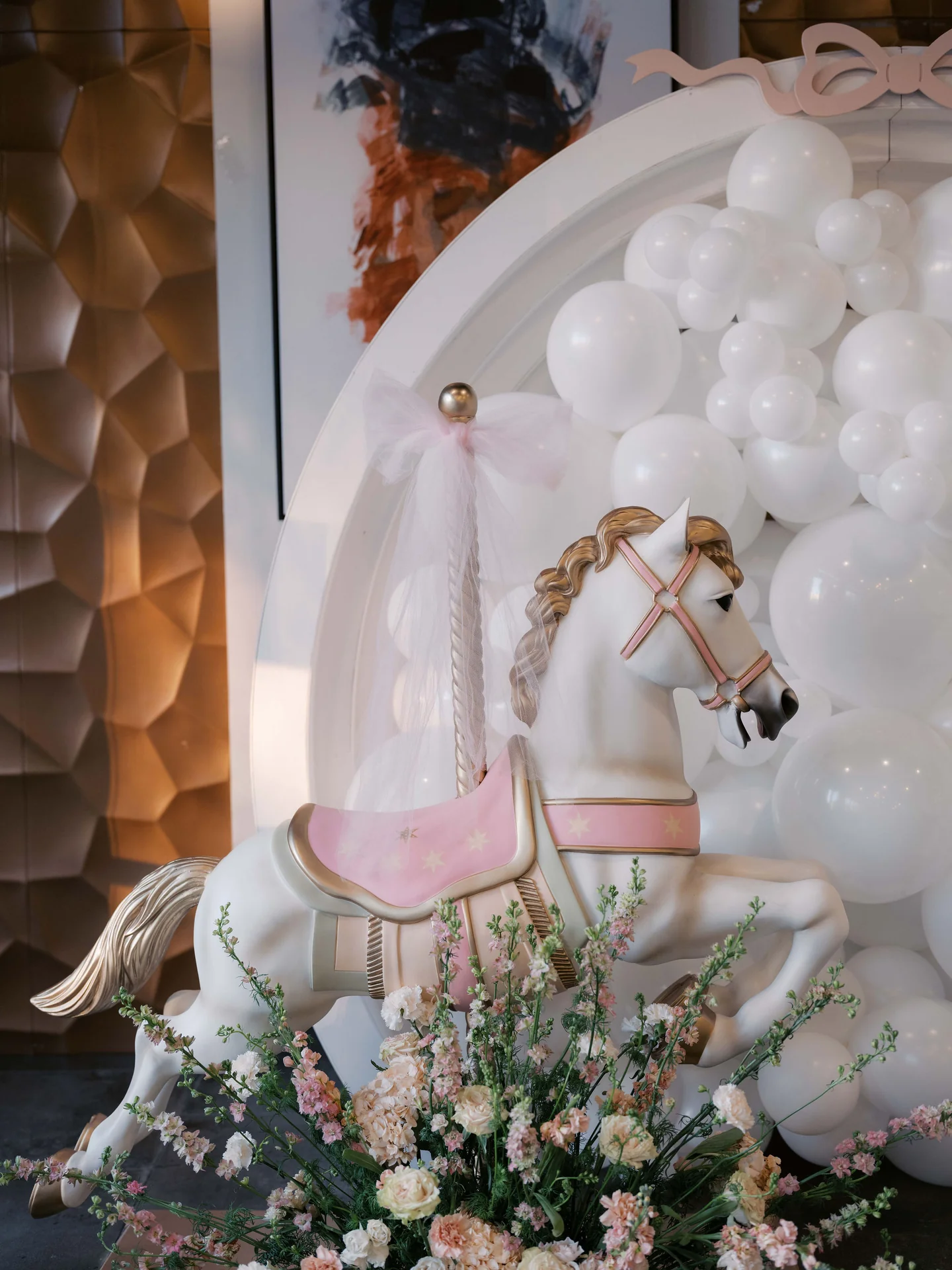 Whimsical carousel display and flowers at Eléonore First Birthday