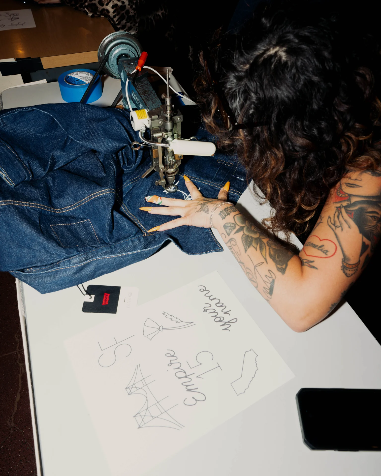 Guest customizing denim at the event activity table at Empire Records 15th Anniversary with Levi's at SF City Hall