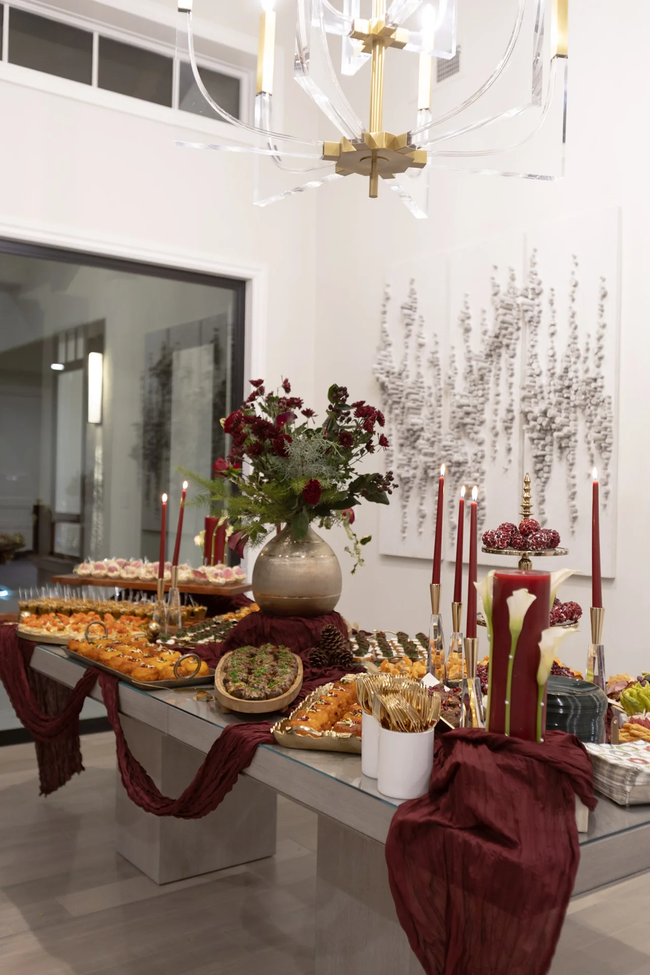 Dining table with candles and floral arrangements at M&E Company Holiday Party