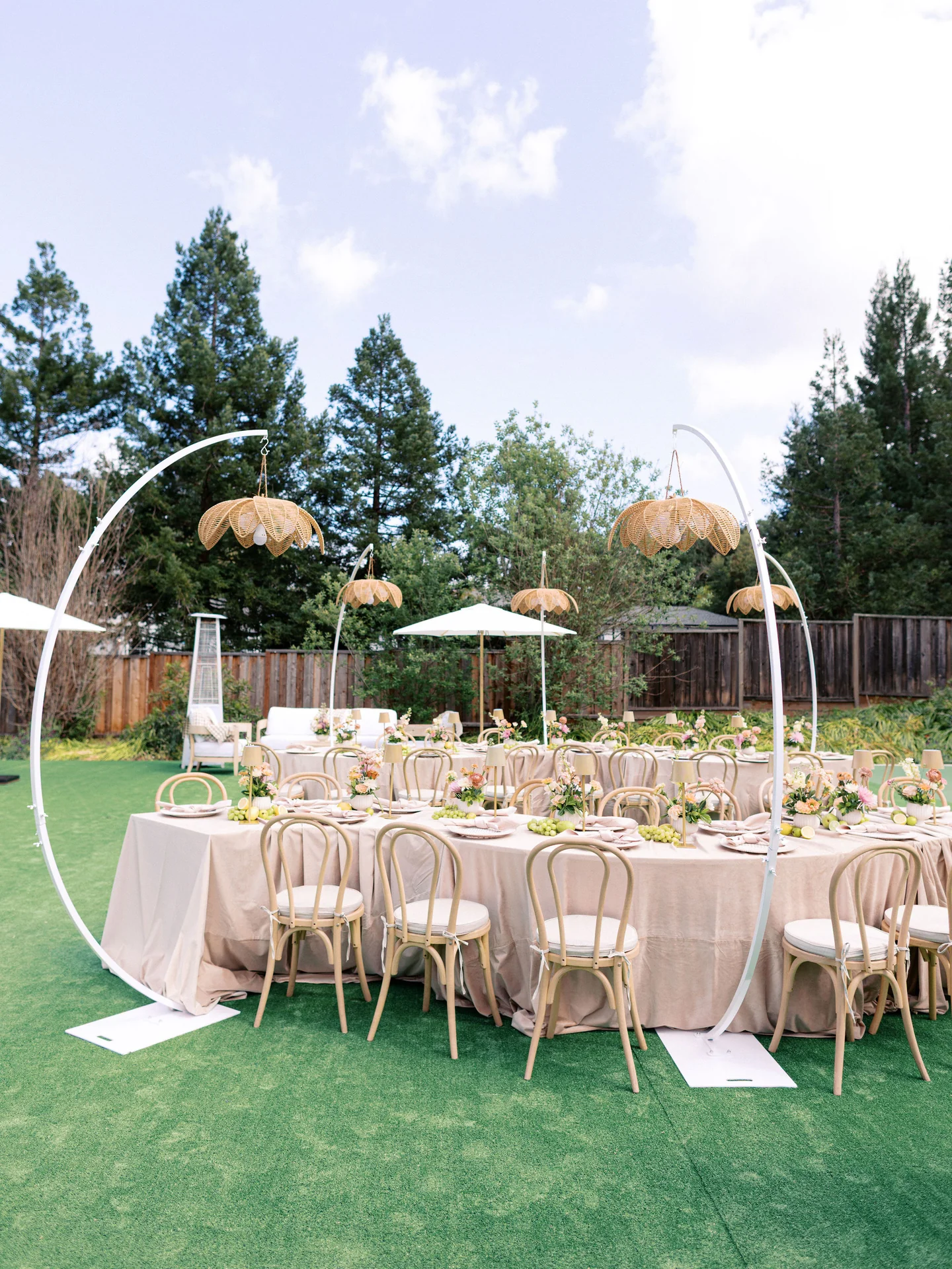 Garden dining tables beneath woven pendant lights at Spring Soiree